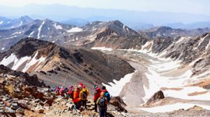Climbers Climbing Snow-capped Alamkuh Mountain